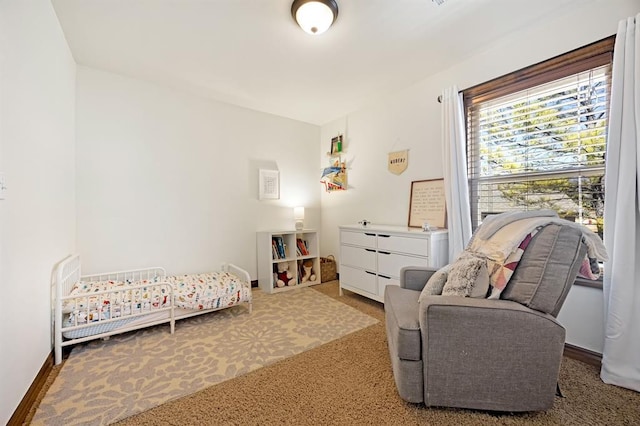 bedroom with baseboards and carpet