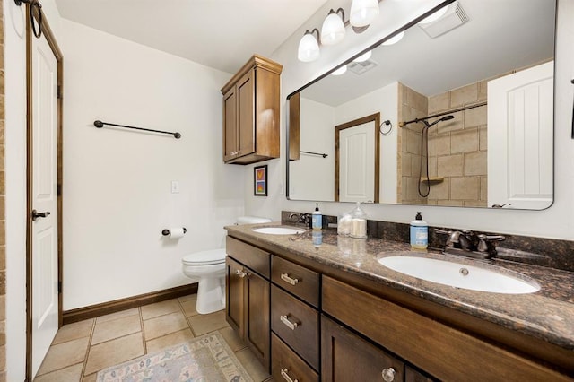 bathroom with toilet, baseboards, visible vents, and a sink