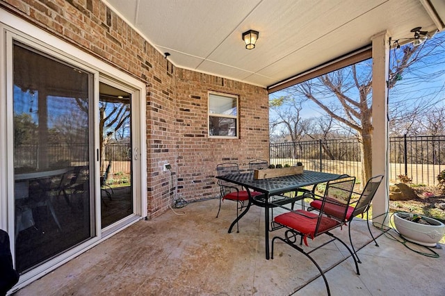 view of patio with outdoor dining area and fence