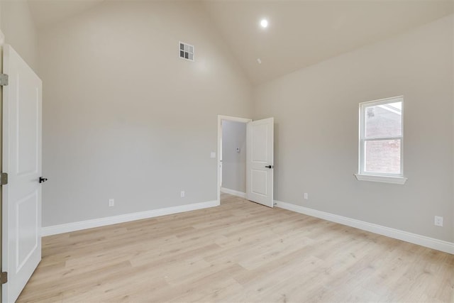 unfurnished room with light wood-type flooring, visible vents, and baseboards