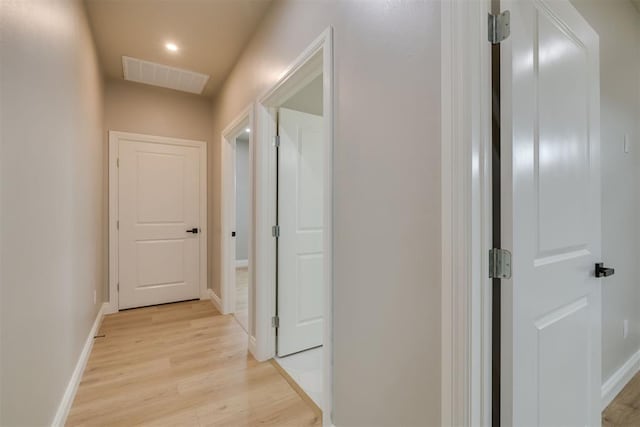 corridor with baseboards, recessed lighting, visible vents, and light wood-style floors