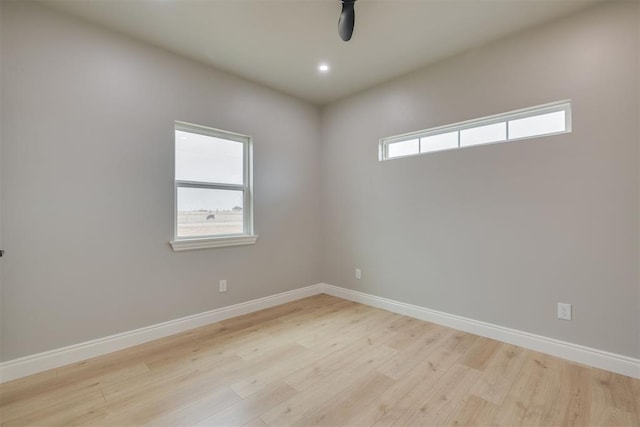 unfurnished room with light wood-type flooring, baseboards, a wealth of natural light, and recessed lighting