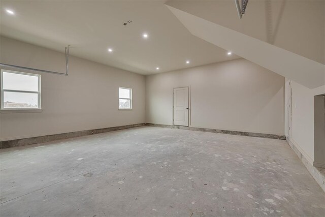 additional living space with concrete floors, recessed lighting, and baseboards