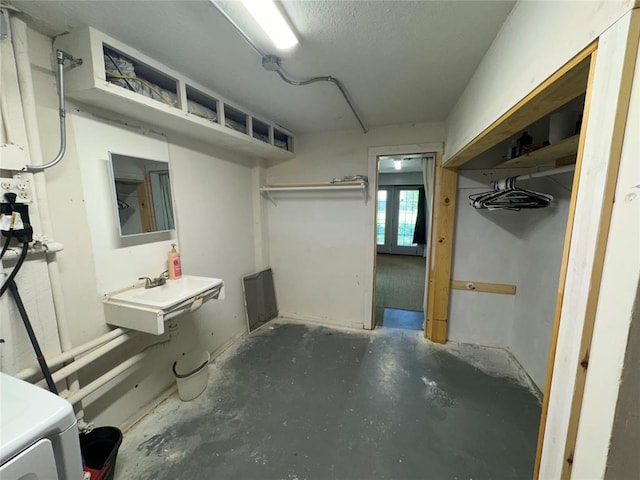 basement with washer / clothes dryer and a sink