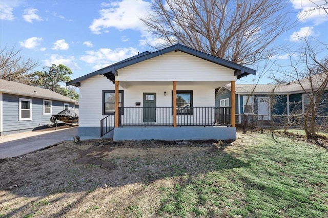 bungalow-style house with covered porch and fence