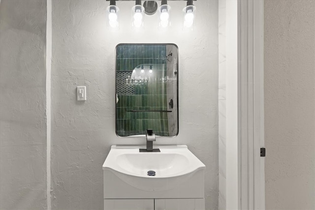 bathroom with a textured wall and vanity