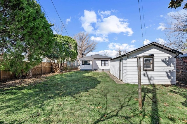 view of yard with a fenced backyard and an outdoor structure