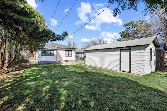 view of yard with fence and an outbuilding