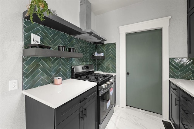 kitchen featuring marble finish floor, open shelves, light countertops, stainless steel gas range oven, and wall chimney exhaust hood