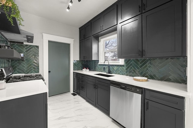 kitchen featuring decorative backsplash, marble finish floor, stainless steel appliances, light countertops, and a sink