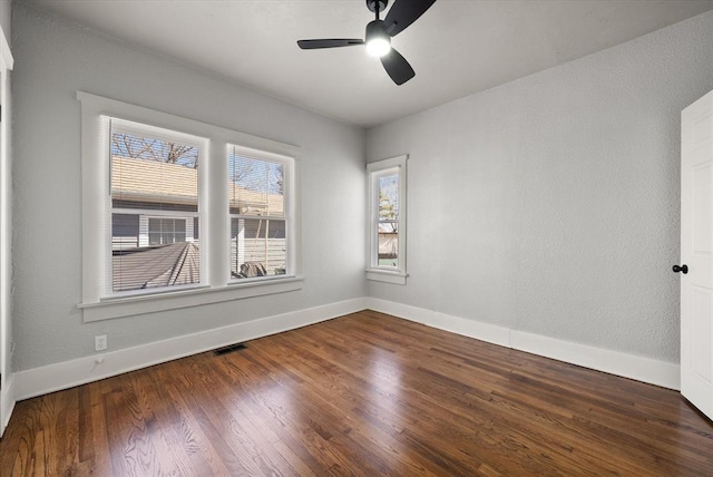 unfurnished room featuring visible vents, ceiling fan, baseboards, and wood finished floors