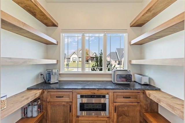 bar featuring stainless steel oven