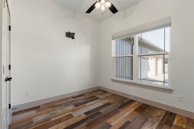 empty room featuring a ceiling fan, baseboards, and wood finished floors