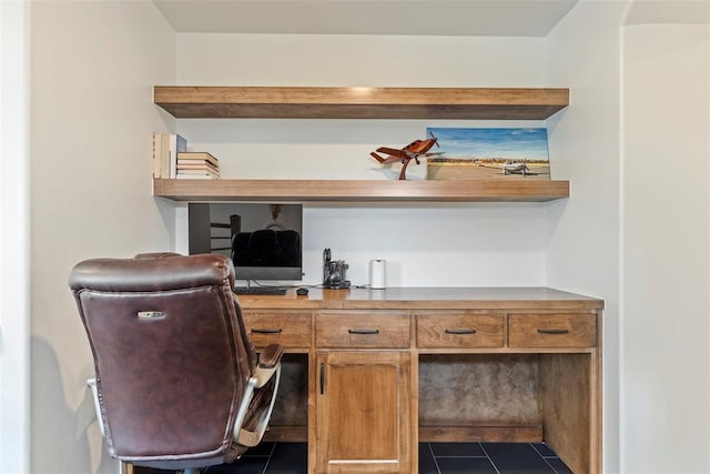 home office with dark tile patterned flooring and built in study area