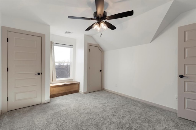 bonus room featuring baseboards, visible vents, a ceiling fan, vaulted ceiling, and carpet flooring