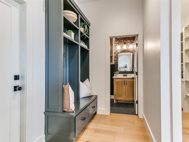 mudroom with light wood-style floors and baseboards