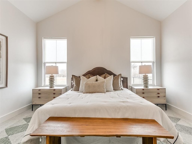 bedroom with lofted ceiling, carpet floors, and baseboards