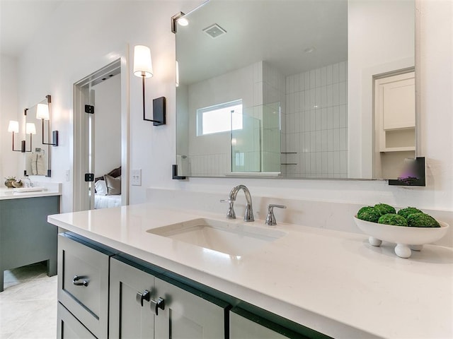 ensuite bathroom featuring visible vents, ensuite bathroom, vanity, tile patterned flooring, and tiled shower