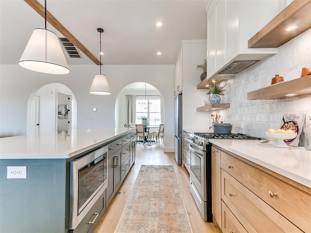 kitchen with visible vents, appliances with stainless steel finishes, light wood-type flooring, open shelves, and backsplash