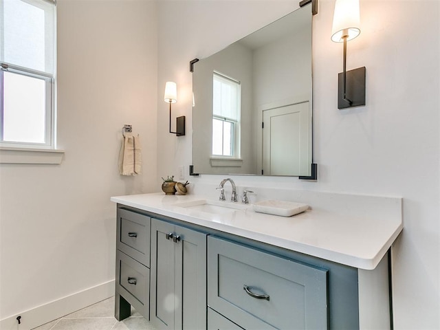 bathroom featuring tile patterned flooring, baseboards, and vanity