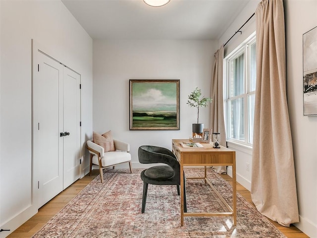 office featuring light wood-type flooring and baseboards