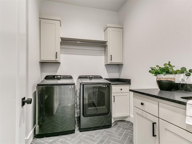 clothes washing area with cabinet space and washing machine and clothes dryer