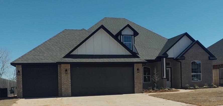 view of front facade featuring a garage, a shingled roof, board and batten siding, and concrete driveway