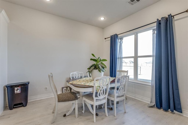 dining space with light wood finished floors, recessed lighting, visible vents, and baseboards