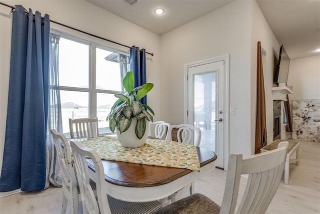 dining area with a healthy amount of sunlight and light wood-style flooring