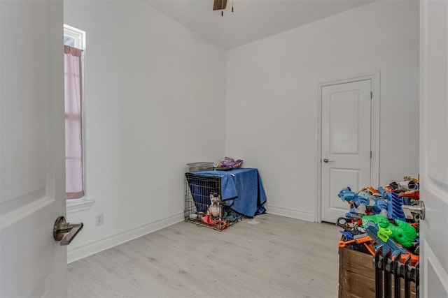 game room with wood finished floors, a ceiling fan, and baseboards