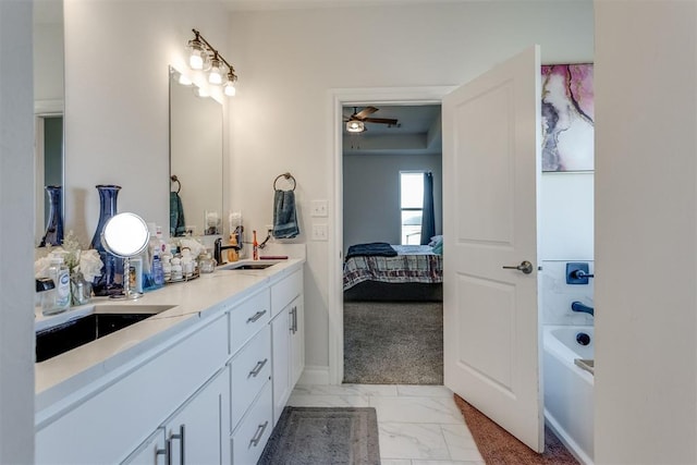 full bathroom featuring marble finish floor, a sink, ensuite bath, and double vanity