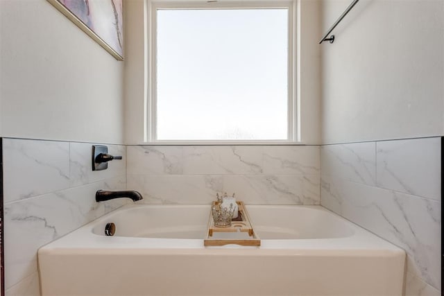 bathroom featuring a garden tub and plenty of natural light