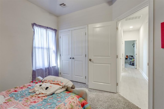 bedroom with a closet and visible vents