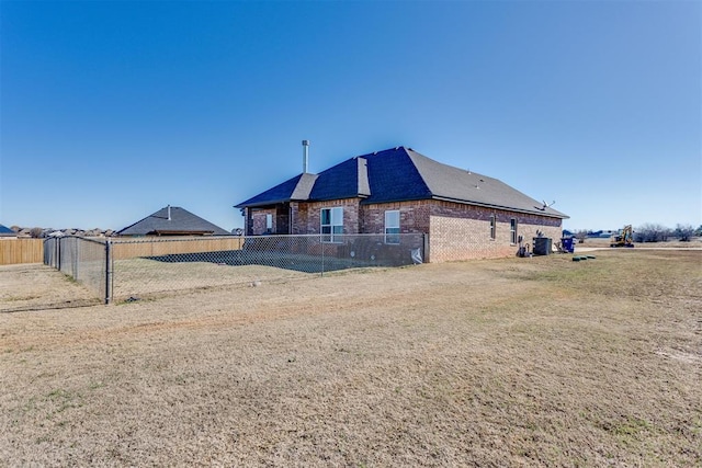 back of house with brick siding and fence