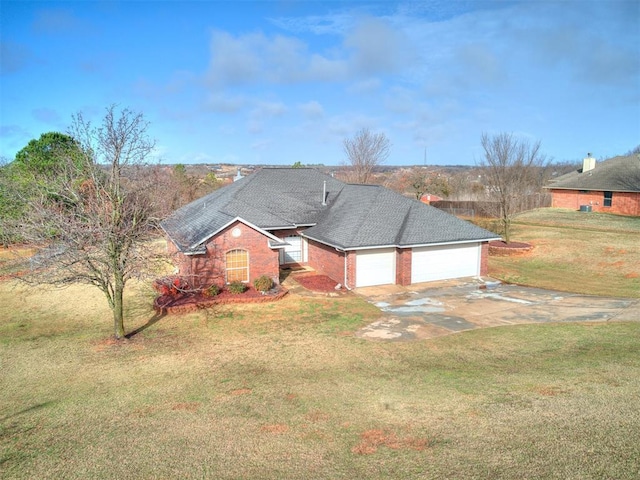 view of front facade featuring an attached garage, brick siding, a shingled roof, driveway, and a front yard