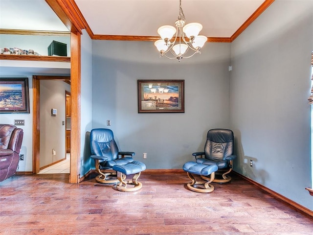 unfurnished room featuring a notable chandelier, baseboards, crown molding, and wood finished floors