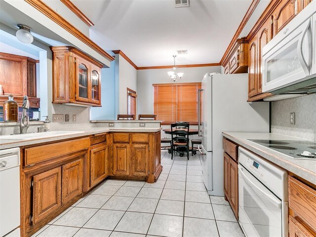 kitchen with white appliances, light tile patterned floors, brown cabinetry, light countertops, and a notable chandelier