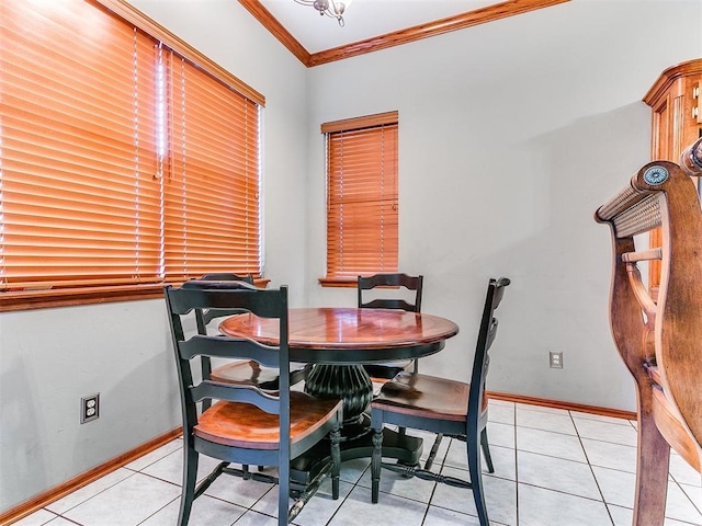 dining area with light tile patterned floors, ornamental molding, and baseboards