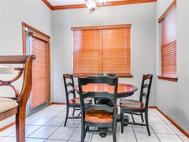 dining room with ornamental molding, a healthy amount of sunlight, baseboards, and light tile patterned floors