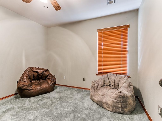 sitting room featuring carpet flooring, ceiling fan, visible vents, and baseboards