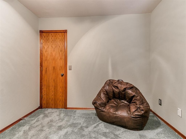 sitting room featuring carpet floors and baseboards