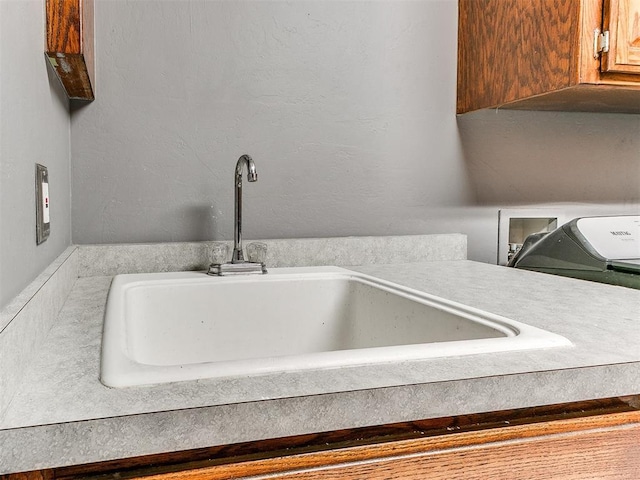 interior details featuring a sink and a textured wall