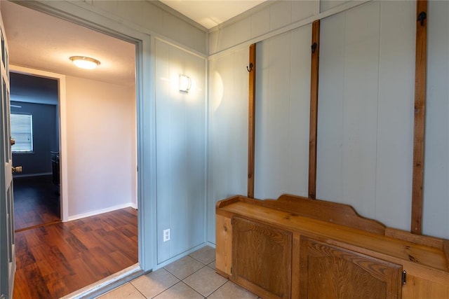 hallway with light tile patterned floors and baseboards