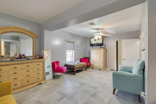 living area with visible vents and a ceiling fan