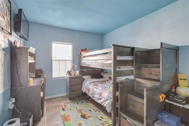 bedroom with tile patterned flooring and baseboards