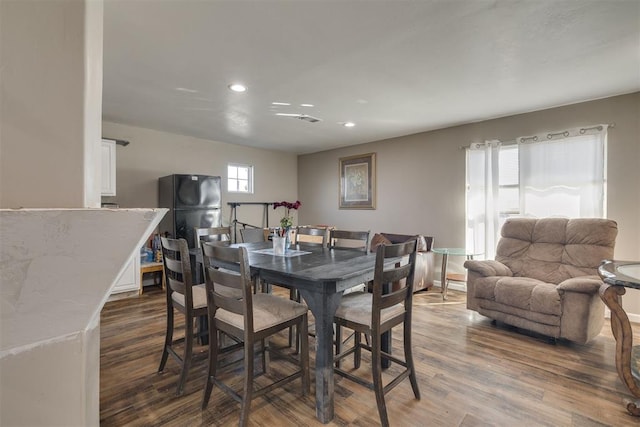 dining area featuring wood finished floors and recessed lighting