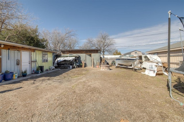 view of yard featuring fence and an outdoor structure