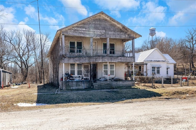 view of front of home with a porch and a balcony