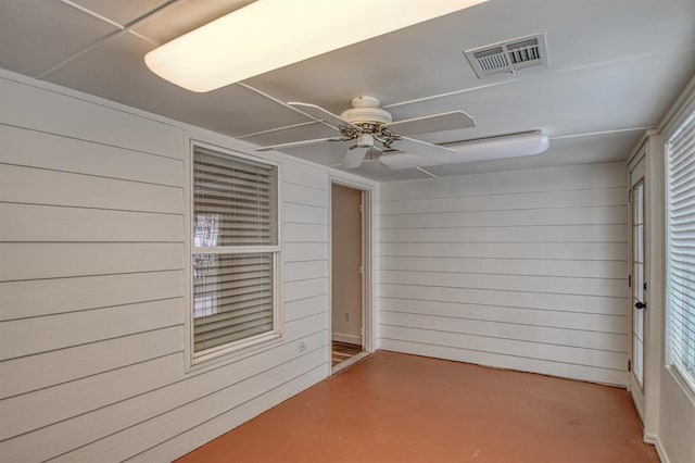 unfurnished sunroom featuring ceiling fan and visible vents