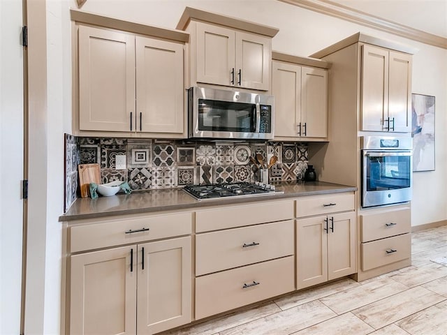 kitchen featuring stainless steel appliances, wood tiled floor, ornamental molding, and tasteful backsplash